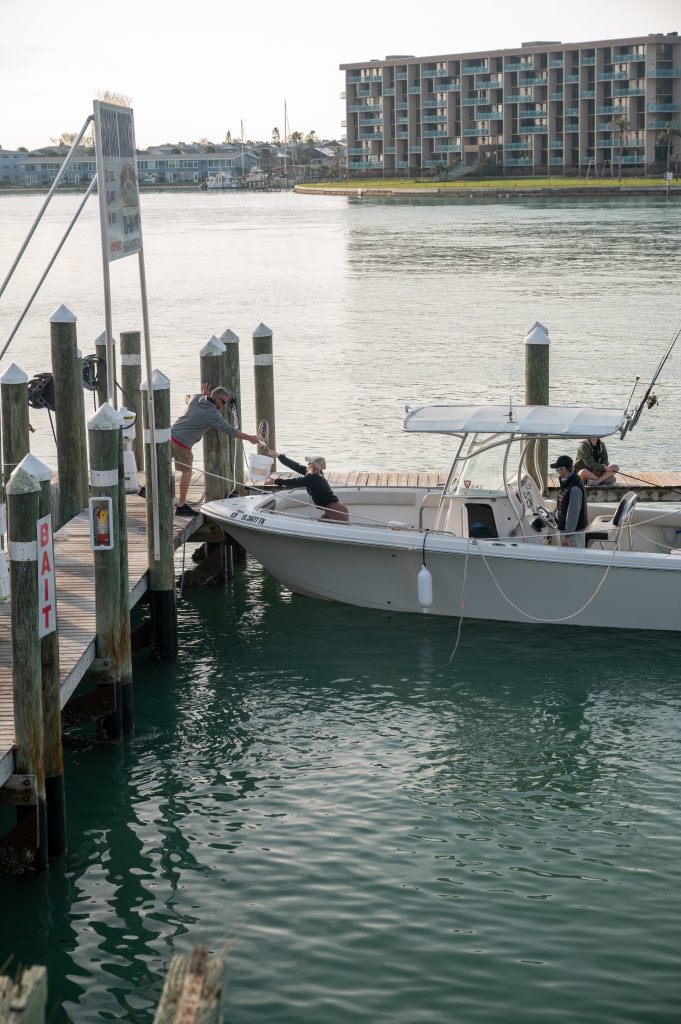 boaters getting bait for their private fishing charter